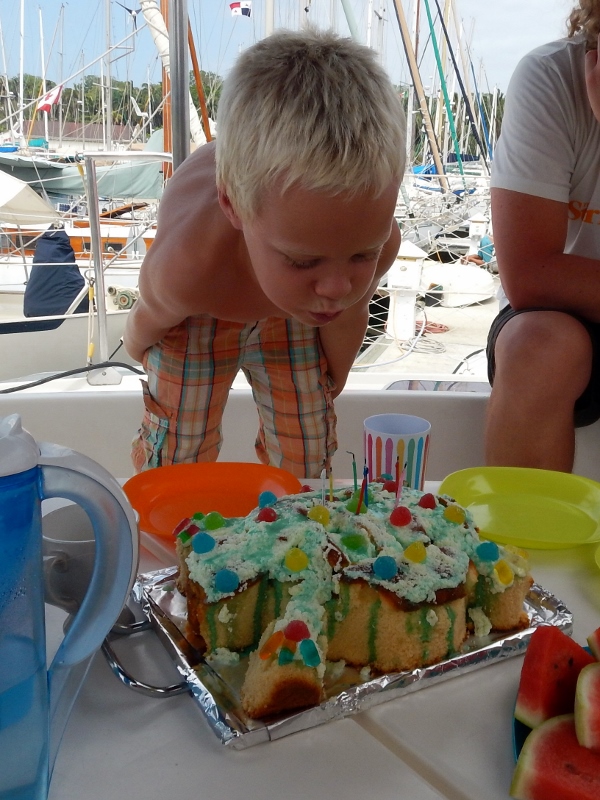 Birthday boy hovering over melting cake