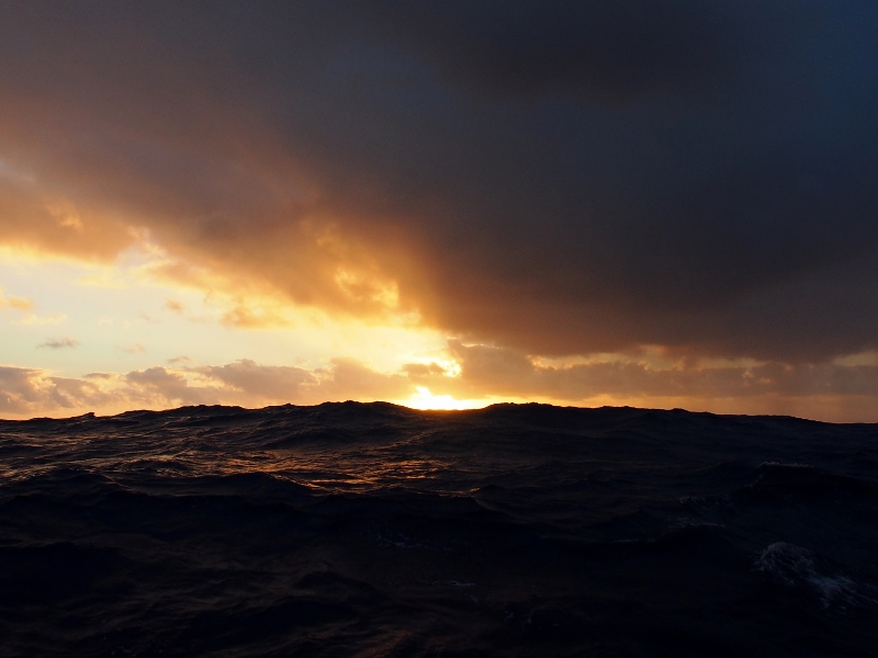 Sun over heavy seas