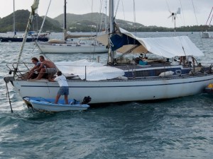 Rescuers trying to hoist the anchor on the drifting boat
