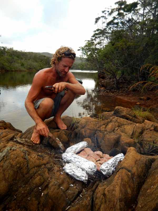 Freshly caught fish and baguette cooked over open fire